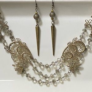 Beautiful ornate gold tone and crystal necklace and earrings